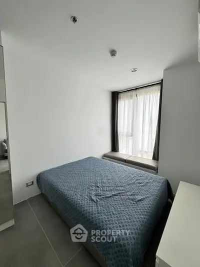 Modern minimalist bedroom with large window and stylish decor