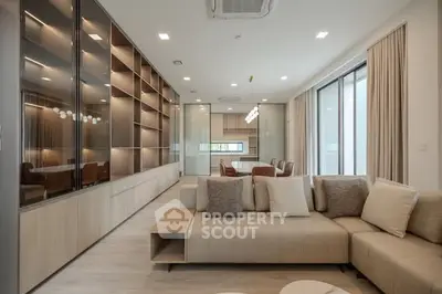 Modern living room with elegant sofa and open kitchen layout