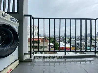 Spacious balcony with city view and washing machine, perfect for urban living.