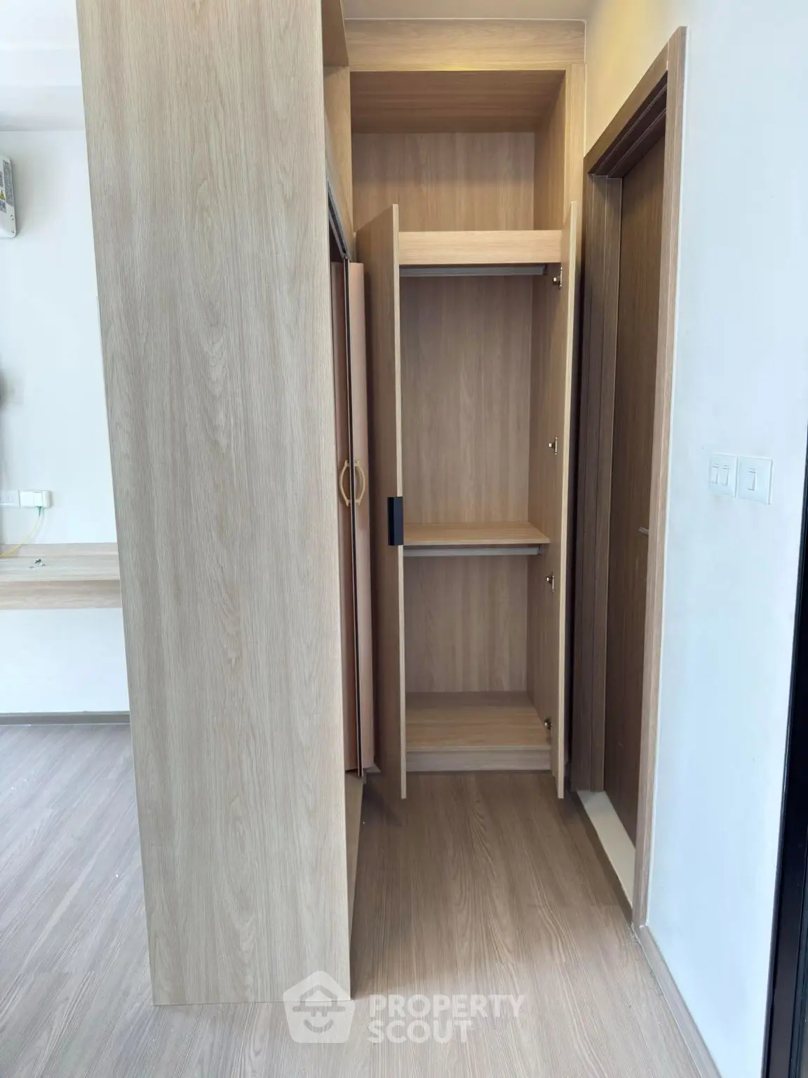 Modern wooden wardrobe in a stylish apartment interior
