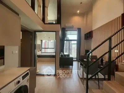 Modern duplex apartment with open living area and stylish interior design.