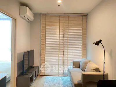 Modern living room with cozy sofa and TV, featuring sleek blinds and air conditioning.