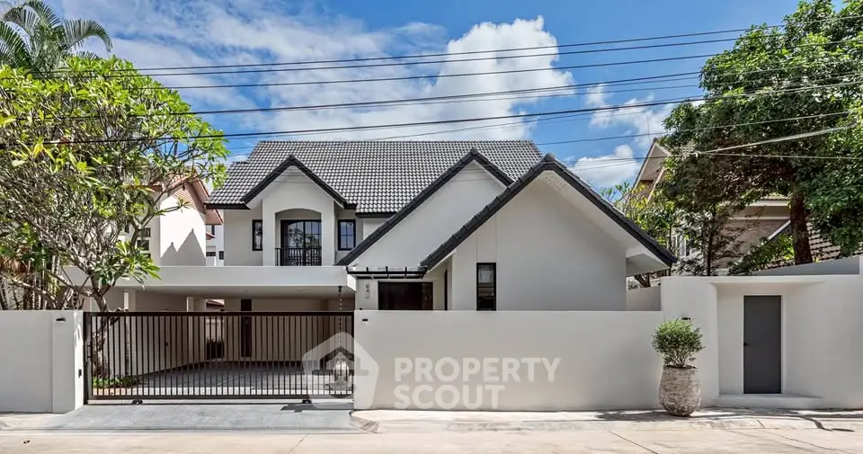 Charming modern house with sleek design and spacious driveway in a serene neighborhood.