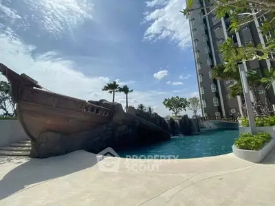 Luxurious apartment complex with stunning pool and unique ship-themed design under a clear blue sky.