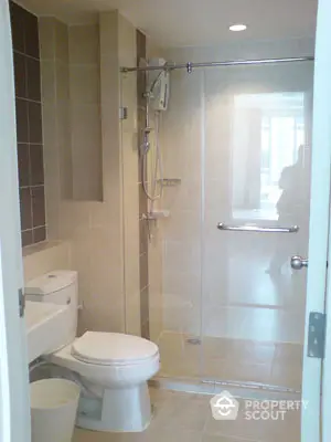 Modern bathroom with glass shower enclosure and sleek fixtures