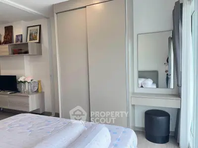 Modern bedroom with sleek closet and cozy decor in a stylish apartment.