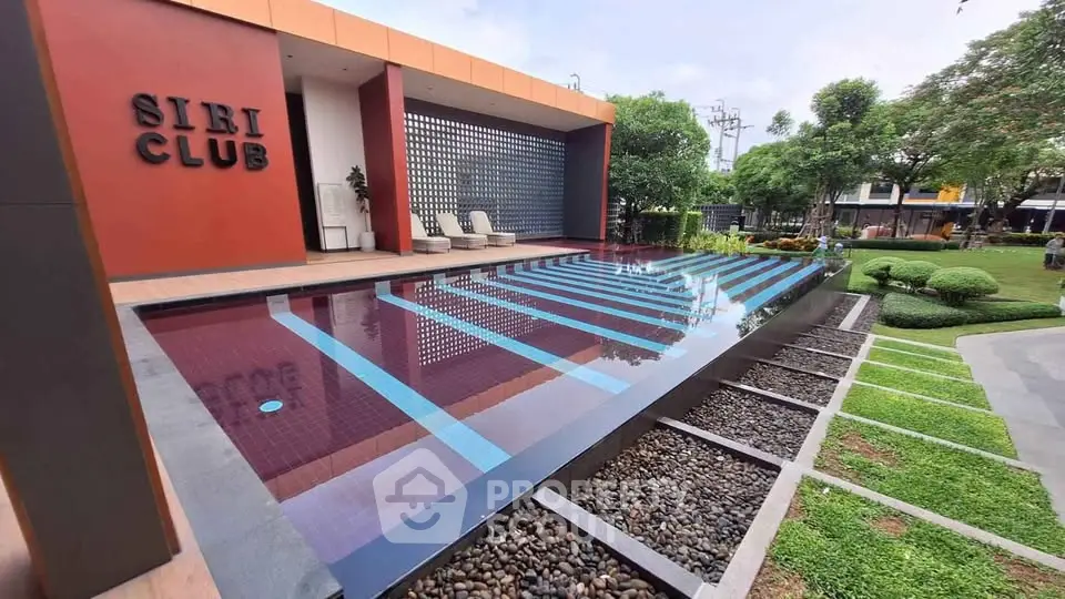 Luxurious outdoor pool area at Siri Club with modern design and lush greenery.