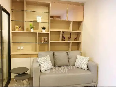 Modern living room with stylish shelving and cozy sofa in a contemporary apartment.