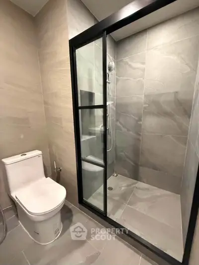 Modern bathroom with sleek shower enclosure and elegant tile design