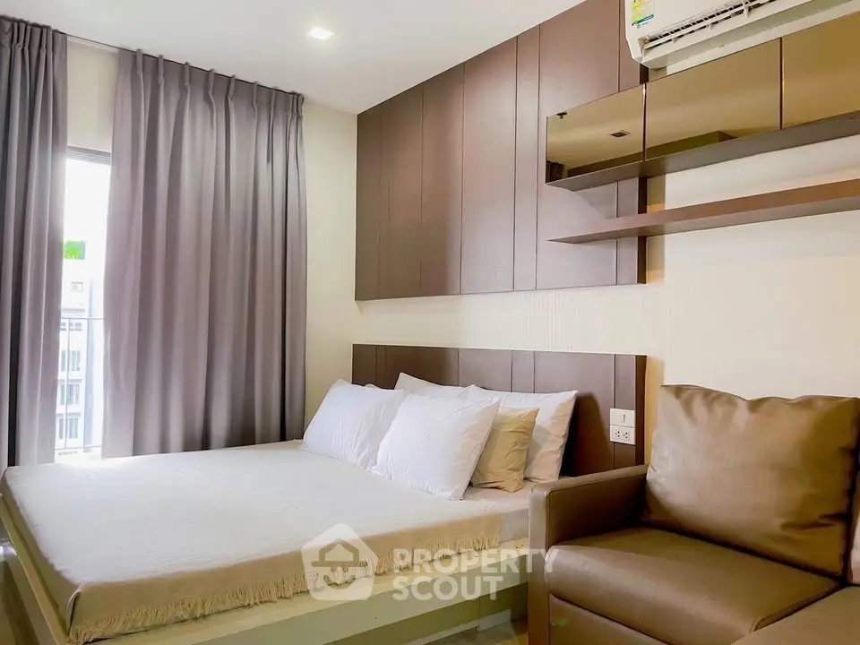 Modern bedroom with cozy bed, elegant curtains, and air conditioning in a stylish apartment.