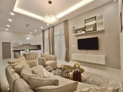 Luxurious open-plan living room with elegant decor and modern lighting