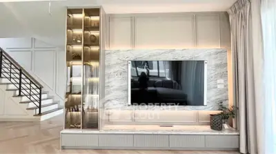 Luxurious living room with modern TV setup and elegant decor