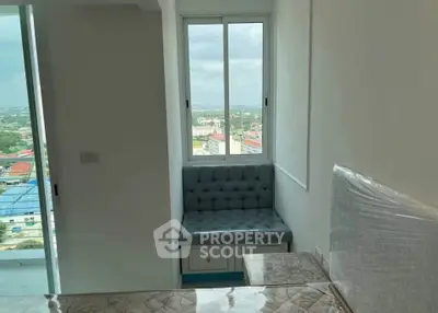 Cozy bedroom with window seating and city view