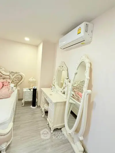 Elegant bedroom with vintage furniture and modern air conditioning unit, showcasing luxury and comfort.
