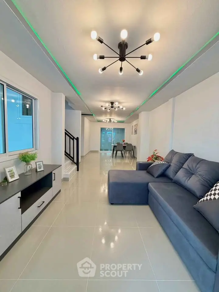 Spacious modern living room with stylish lighting and comfortable seating