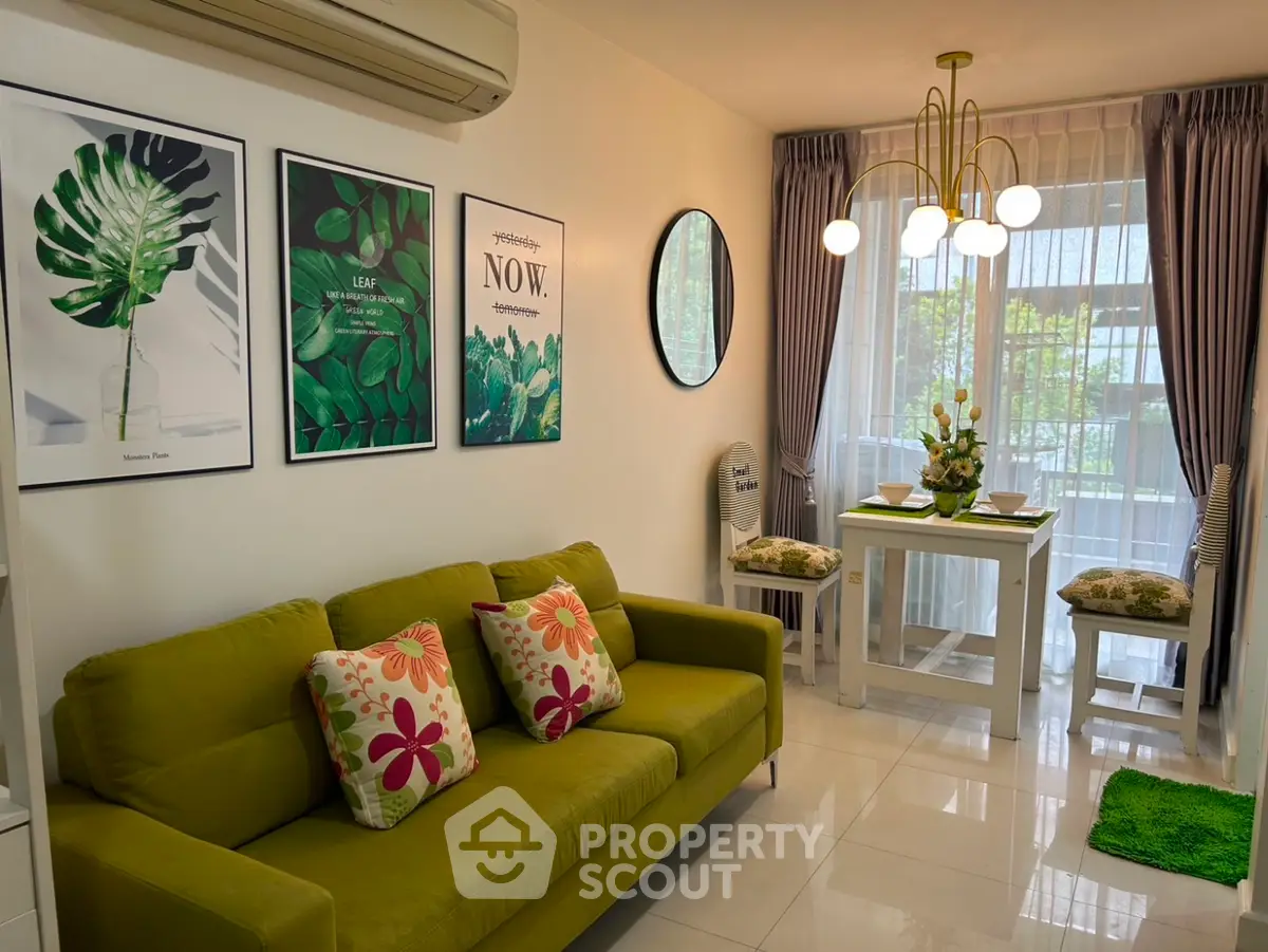 Charming living room with green sofa, modern decor, and dining area by large window.