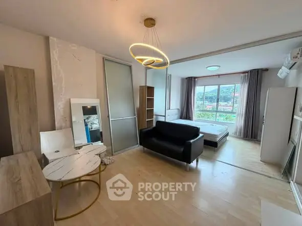 Modern studio apartment with open layout and scenic window view