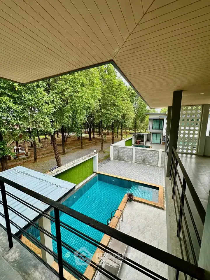 Modern apartment with pool view and lush greenery from balcony