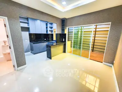Modern kitchen with sleek design and open layout, featuring glossy cabinets and a spacious feel.