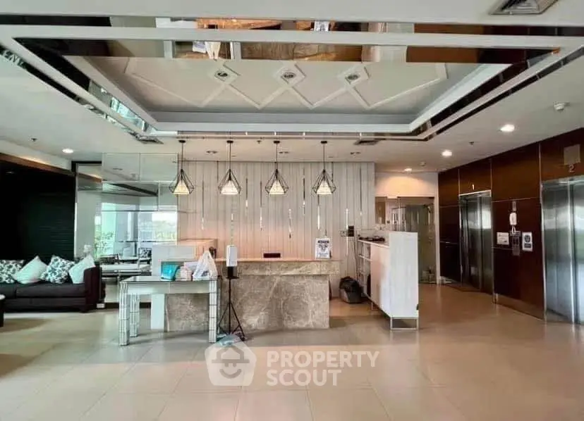 Luxurious modern lobby with elegant lighting and stylish seating area in a high-end building.