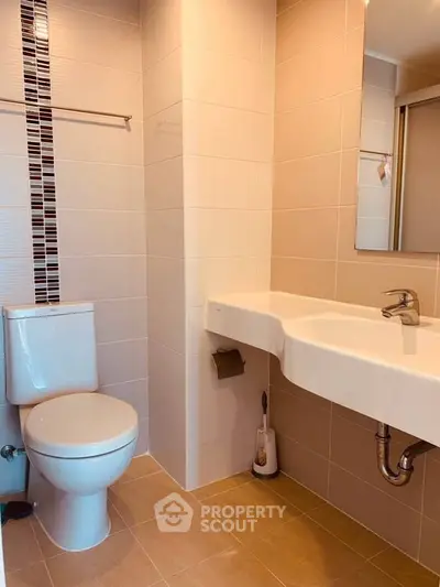 Modern bathroom with sleek fixtures and stylish tile accents in a contemporary home.
