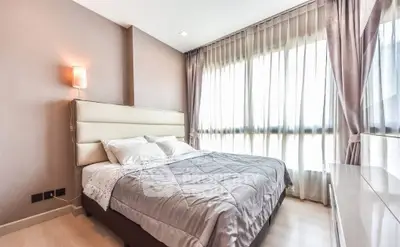 Modern bedroom with large windows and elegant decor