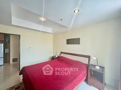 Spacious bedroom with elegant decor and modern lighting in a luxurious apartment.