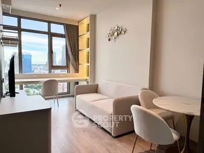 Modern living room with city view, featuring elegant furniture and large windows for natural light.