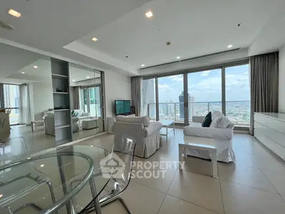 Spacious modern living room with panoramic city view and elegant furnishings.
