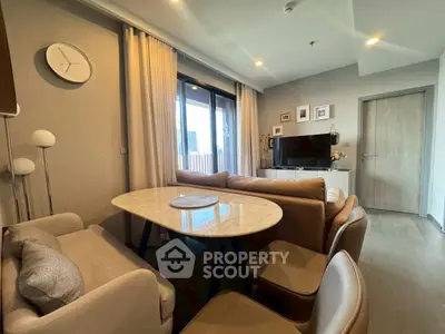 Modern living room with stylish furniture and large window view