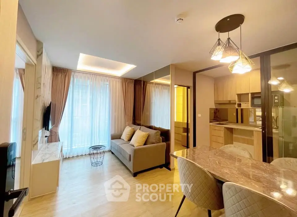 Modern open-plan living room with elegant kitchen and stylish lighting