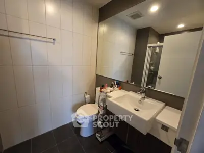 Modern bathroom with sleek fixtures and large mirror