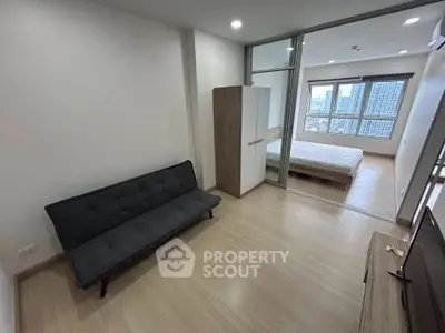 Modern apartment interior with cozy living area and bedroom view