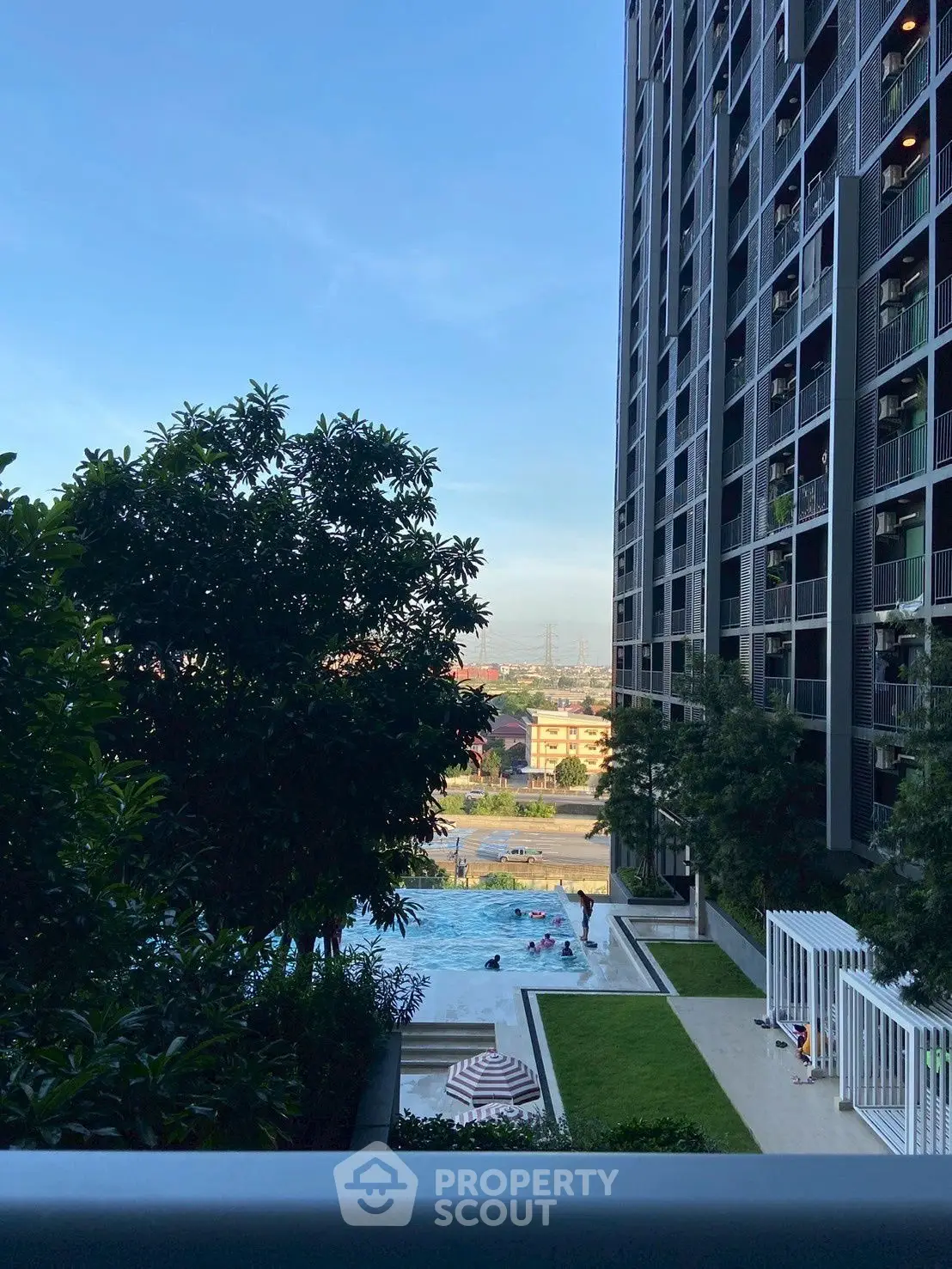 Modern high-rise building with pool and garden view