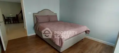 Cozy bedroom with elegant bed and wooden flooring in modern apartment