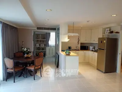 Spacious open-layout kitchen and dining area with modern appliances and elegant decor.