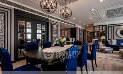 Luxurious dining room with elegant decor and plush blue chairs in a sophisticated apartment.