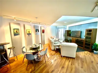 Stylish open-plan living room with modern decor and wooden flooring