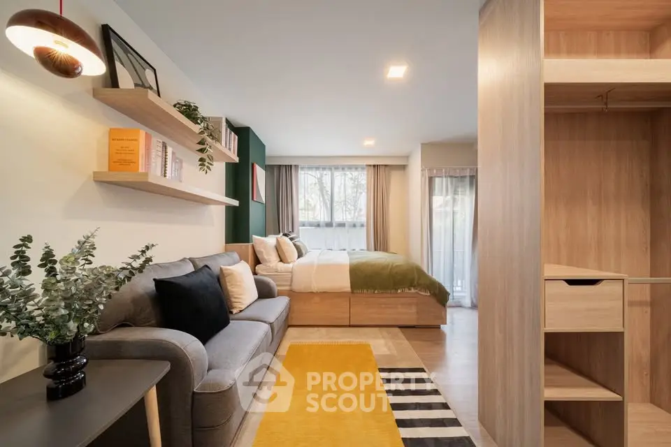 Modern studio apartment with cozy living area and stylish bedroom