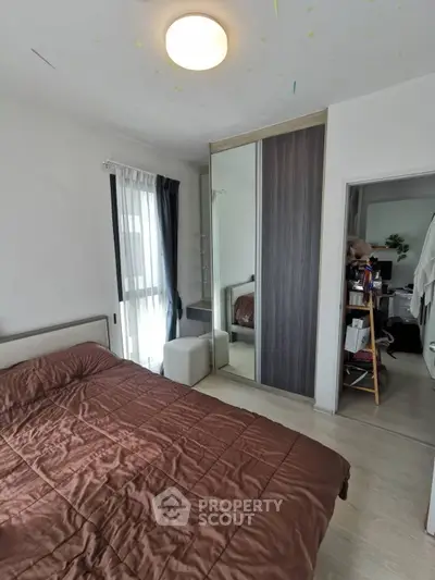 Cozy bedroom with modern wardrobe and natural light