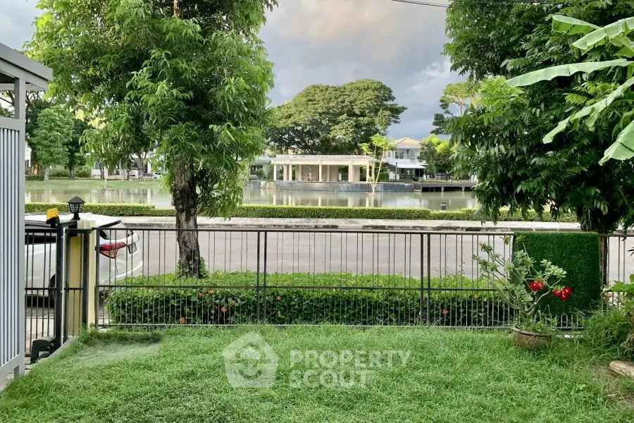 Charming garden view with lush greenery and serene lakefront setting.