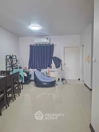 Spacious living room with modern decor and air conditioning, perfect for comfortable living.