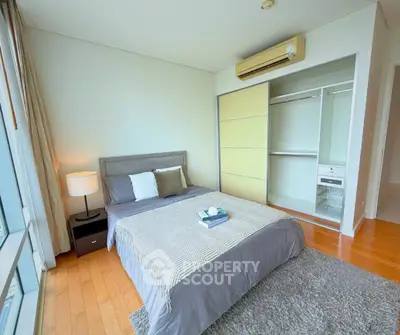 Spacious bedroom with modern decor and large window view