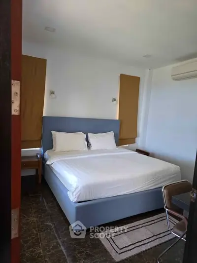 Modern bedroom with stylish decor and comfortable bed in a real estate property.