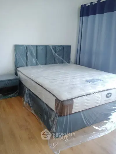 Spacious bedroom with new mattress and stylish curtains, perfect for comfort and relaxation.