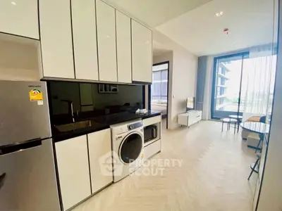 Modern kitchen with sleek cabinets and built-in appliances in a bright apartment.