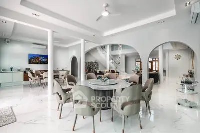 Luxurious open-plan living and dining area with modern decor and marble flooring.