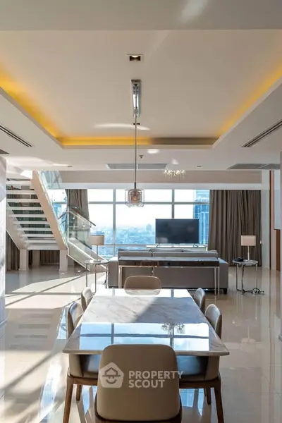 Luxurious open-plan living room with dining area and panoramic city views, featuring modern decor and elegant lighting.