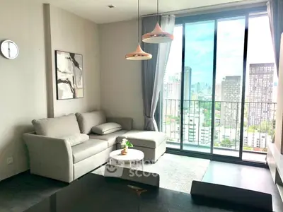 Modern living room with city view, stylish decor, and large windows for natural light.