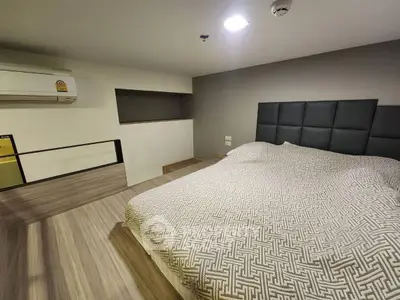 Modern bedroom with stylish decor and air conditioning in a cozy apartment.